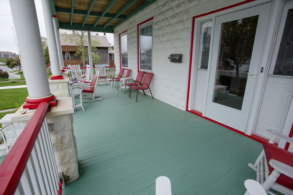 The front porch: red railings, sea-foam floor, room for everyone.